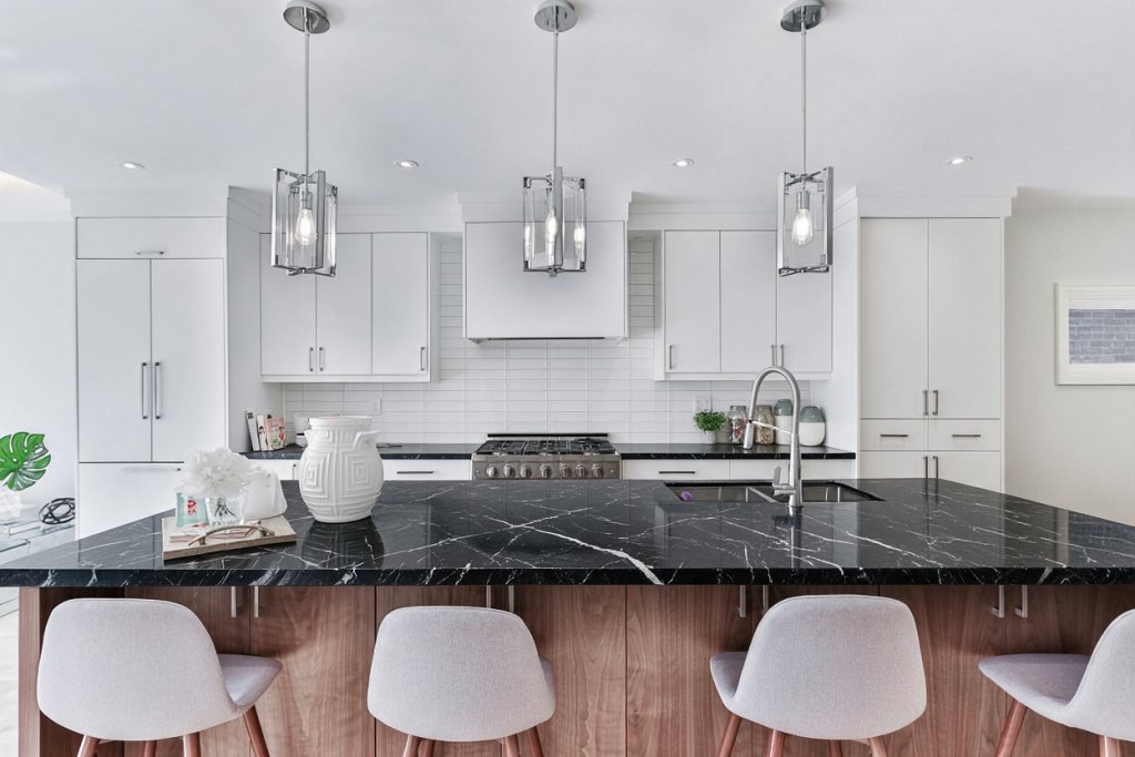 The same kitchen rendered with a Nero Marquina island and counters